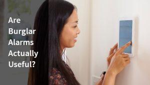 Lady checking and setting her burglar alarms.