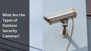 Outdoor security camera mounted on a blue wall.